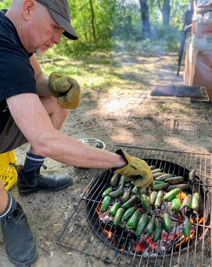 Colin roasting jalapenos over the fire pit