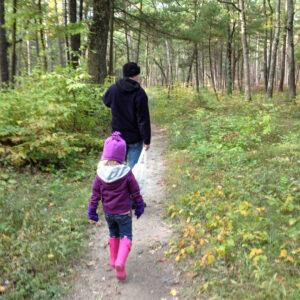 Dad and daughter on a hiking trail on a fall day